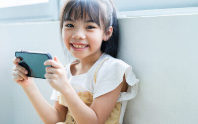 Asian child using smartphone at home